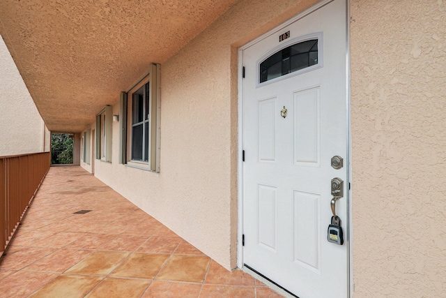 doorway to property featuring stucco siding