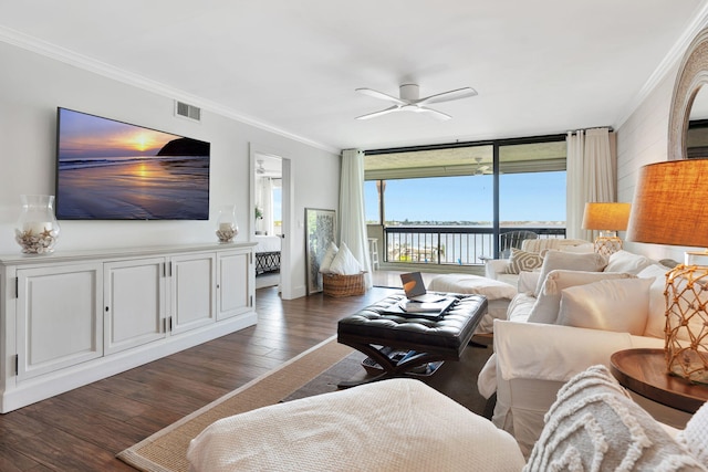 living area featuring a water view, visible vents, ornamental molding, and wood finished floors