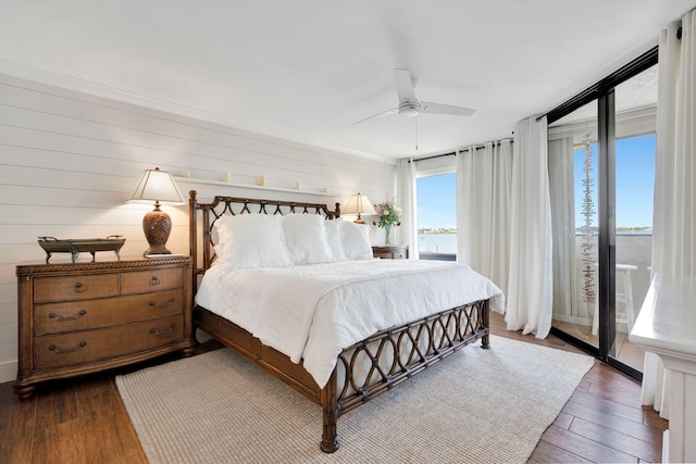 bedroom featuring access to outside, ceiling fan, and wood finished floors