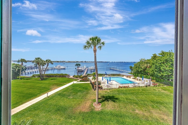 community pool featuring a water view and a yard