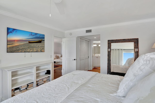 bedroom with ornamental molding, wood finished floors, and visible vents