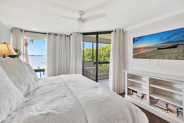 bedroom with ornamental molding, multiple windows, wood finished floors, and access to exterior