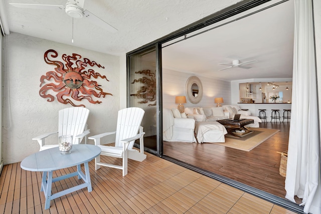 sitting room featuring ceiling fan