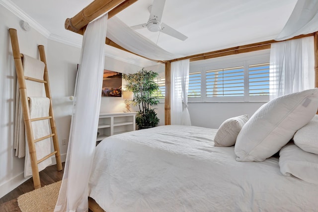 bedroom with ornamental molding, a ceiling fan, and wood finished floors