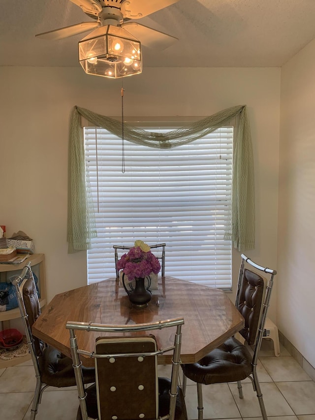 dining room featuring ceiling fan and light tile patterned flooring