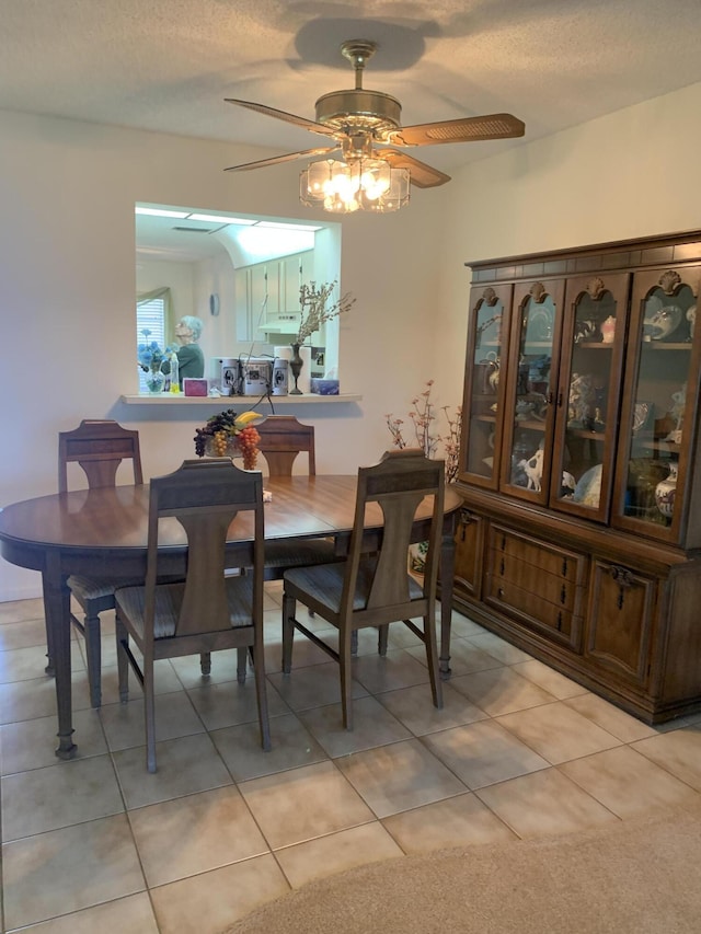 dining space featuring ceiling fan, a textured ceiling, and light tile patterned floors