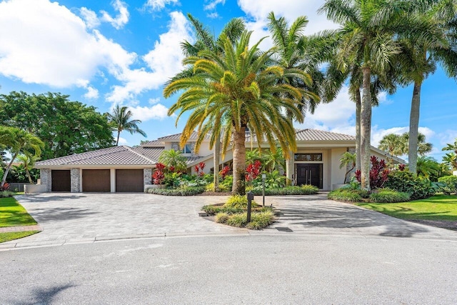 17906 Aberdeen Way, Boca Raton, FL 33496 - view of front facade with driveway, a tiled roof, stucco siding, and a garage