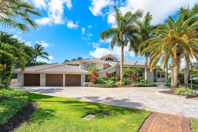 17906 Aberdeen Way, Boca Raton, FL 33496 - view of front of home with decorative driveway, a garage, stucco siding, a tiled roof, and a front lawn