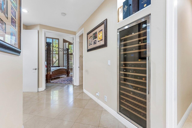 17906 Aberdeen Way, Boca Raton, FL 33496 - hall with beverage cooler, baseboards, and light tile patterned floors