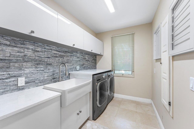 17906 Aberdeen Way, Boca Raton, FL 33496 - laundry room with cabinet space, baseboards, separate washer and dryer, and light tile patterned floors