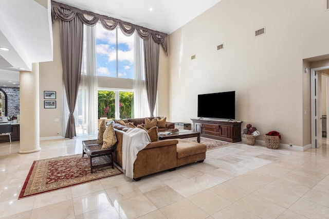 17906 Aberdeen Way, Boca Raton, FL 33496 - living room featuring a high ceiling, light tile patterned flooring, baseboards, and ornate columns