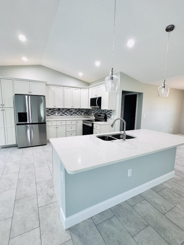 kitchen with a sink, lofted ceiling, decorative light fixtures, and stainless steel appliances