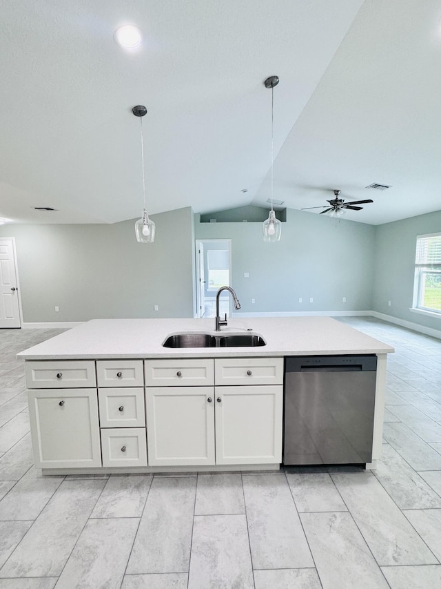 kitchen with decorative light fixtures, stainless steel dishwasher, a sink, light countertops, and open floor plan