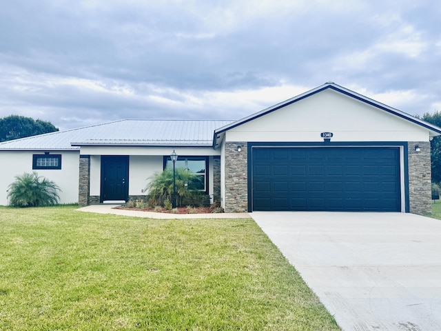 single story home with driveway, a front lawn, an attached garage, stone siding, and stucco siding