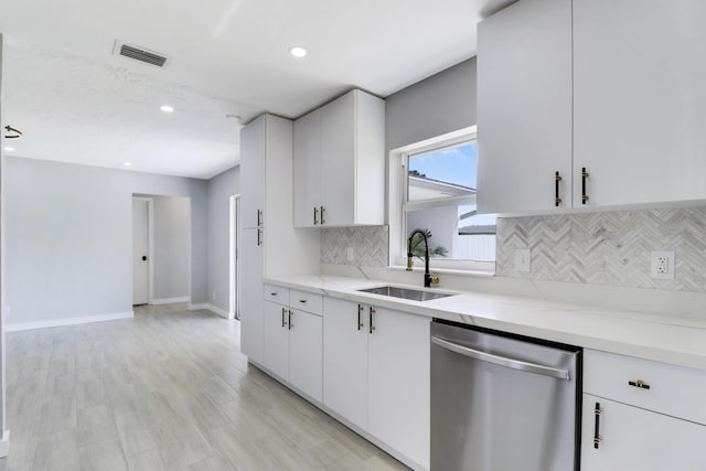 2732 Starwood Cir, West Palm Beach, FL 33406 - kitchen with dishwasher, a sink, backsplash, white cabinets, and recessed lighting