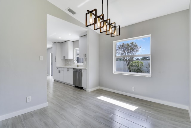 2732 Starwood Cir, West Palm Beach, FL 33406 - unfurnished dining area with baseboards, wood tiled floors, a sink, and a chandelier