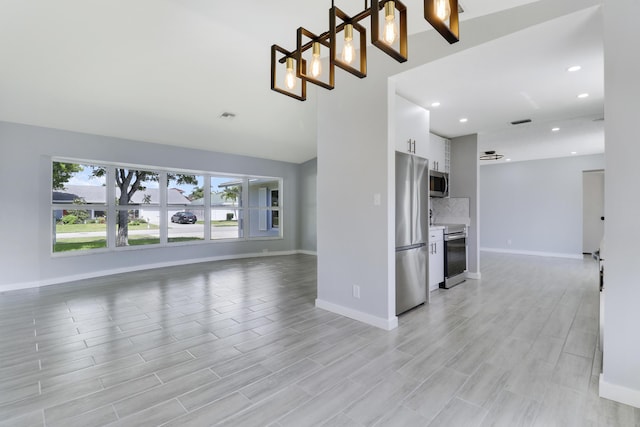 2732 Starwood Cir, West Palm Beach, FL 33406 - unfurnished living room featuring baseboards, recessed lighting, and light wood-style flooring