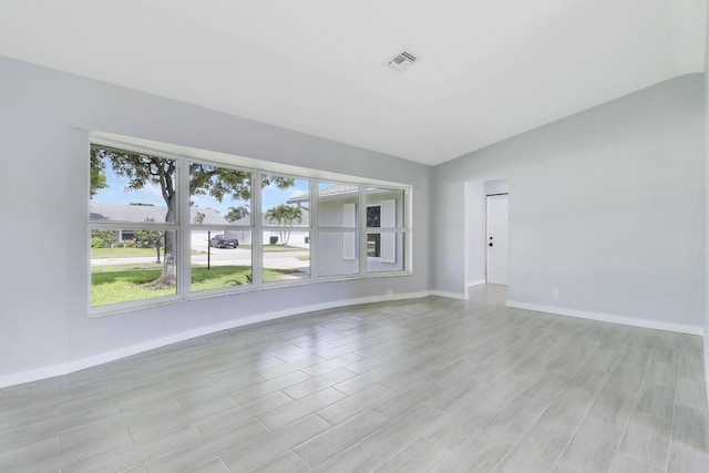 2732 Starwood Cir, West Palm Beach, FL 33406 - empty room with lofted ceiling, baseboards, and light wood finished floors