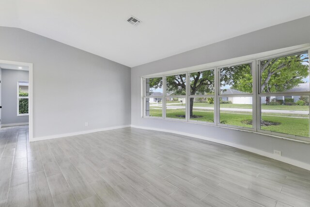 2732 Starwood Cir, West Palm Beach, FL 33406 - spare room with lofted ceiling, baseboards, and light wood finished floors