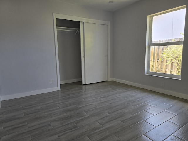 2732 Starwood Cir, West Palm Beach, FL 33406 - unfurnished bedroom with a closet, dark wood finished floors, and baseboards