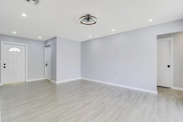 2732 Starwood Cir, West Palm Beach, FL 33406 - unfurnished living room featuring baseboards, light wood finished floors, and recessed lighting