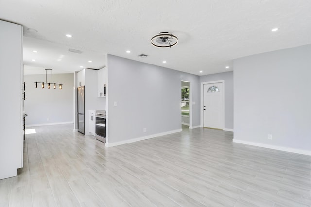 2732 Starwood Cir, West Palm Beach, FL 33406 - unfurnished living room featuring recessed lighting, baseboards, and light wood-style floors