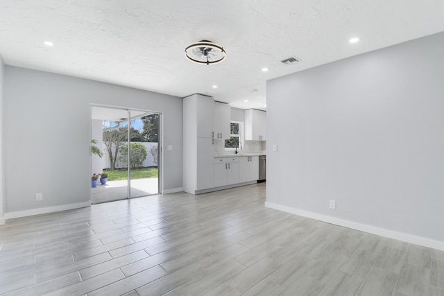 2732 Starwood Cir, West Palm Beach, FL 33406 - unfurnished living room featuring baseboards, light wood finished floors, and recessed lighting