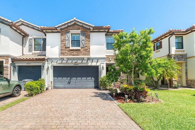 12949 Anthorne Ln, Boynton Beach, FL 33436 - view of property with an attached garage, a tile roof, stone siding, and stucco siding
