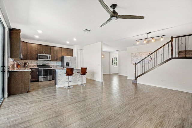 12949 Anthorne Ln, Boynton Beach, FL 33436 - kitchen with dark brown cabinetry, a ceiling fan, visible vents, appliances with stainless steel finishes, and open floor plan