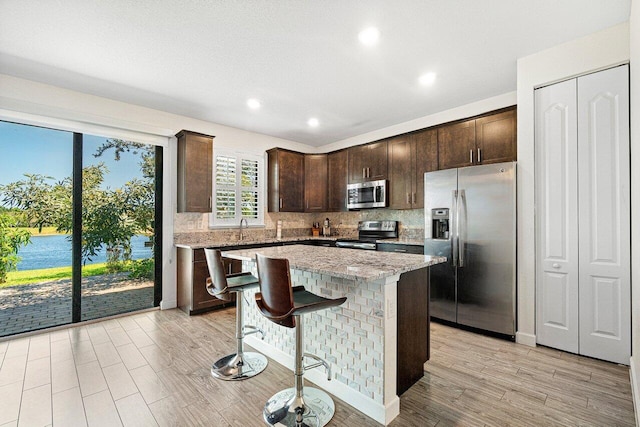 12949 Anthorne Ln, Boynton Beach, FL 33436 - kitchen featuring light wood-style floors, backsplash, stainless steel appliances, and dark brown cabinets