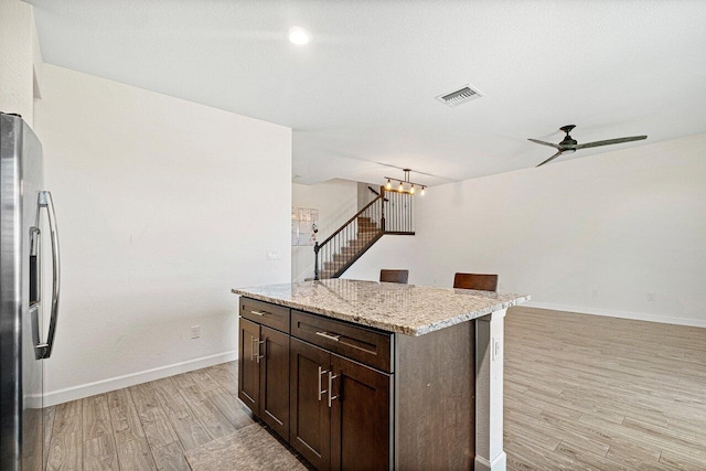 12949 Anthorne Ln, Boynton Beach, FL 33436 - kitchen featuring visible vents, dark brown cabinets, baseboards, stainless steel fridge, and light wood finished floors