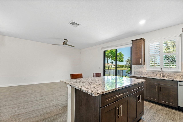 12949 Anthorne Ln, Boynton Beach, FL 33436 - kitchen with ceiling fan, visible vents, a sink, light stone counters, and light wood-style flooring