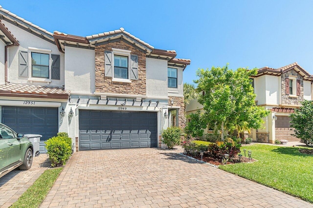 12949 Anthorne Ln, Boynton Beach, FL 33436 - view of property with stucco siding, an attached garage, a tile roof, and stone siding