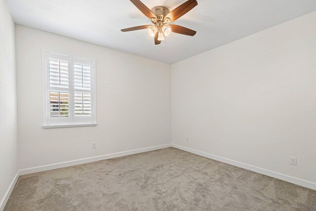 12949 Anthorne Ln, Boynton Beach, FL 33436 - carpeted spare room featuring baseboards and a ceiling fan