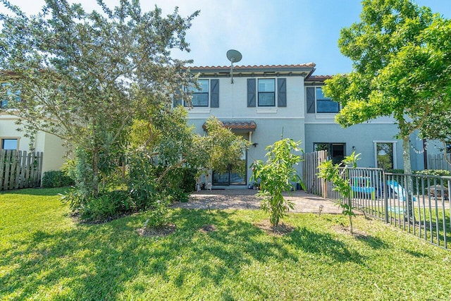 12949 Anthorne Ln, Boynton Beach, FL 33436 - view of front of property featuring stucco siding, a front lawn, fence, and a tile roof