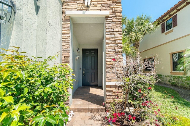 12949 Anthorne Ln, Boynton Beach, FL 33436 - entrance to property with stucco siding and stone siding