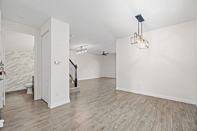 12949 Anthorne Ln, Boynton Beach, FL 33436 - unfurnished living room featuring a ceiling fan, baseboards, stairway, and light wood-style floors