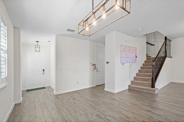 12949 Anthorne Ln, Boynton Beach, FL 33436 - unfurnished living room featuring visible vents, baseboards, stairs, and wood finished floors