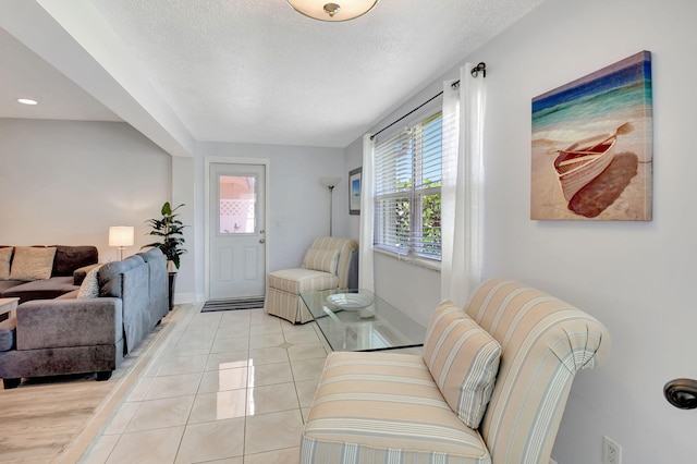 124 Mockingbird Ln Unit 124, Delray Beach, FL 33445 - living room with light tile patterned floors, baseboards, and a textured ceiling