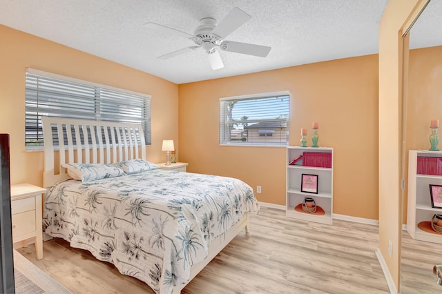 124 Mockingbird Ln Unit 124, Delray Beach, FL 33445 - bedroom with wood finished floors, baseboards, a textured ceiling, and a ceiling fan