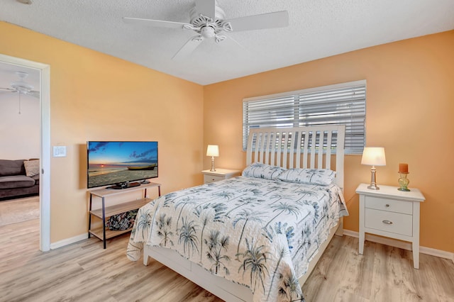 124 Mockingbird Ln Unit 124, Delray Beach, FL 33445 - bedroom with wood finished floors, baseboards, a textured ceiling, and ceiling fan