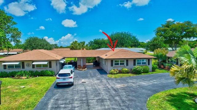 124 Mockingbird Ln Unit 124, Delray Beach, FL 33445 - ranch-style home with asphalt driveway, a front yard, and stucco siding