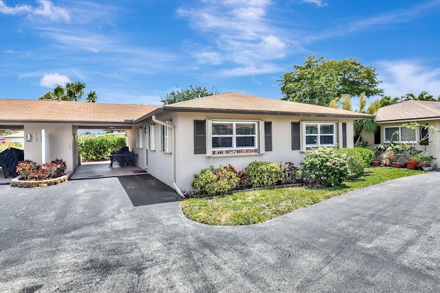124 Mockingbird Ln Unit 124, Delray Beach, FL 33445 - ranch-style house featuring a carport and stucco siding
