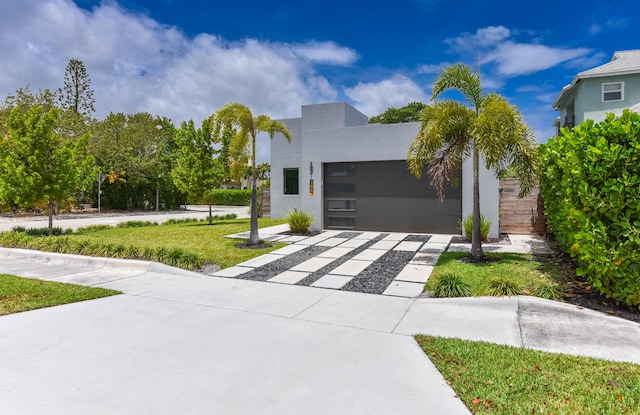 188 Yale Dr, Lake Worth Beach, FL 33460 - contemporary house with driveway, stucco siding, an attached garage, and a front yard