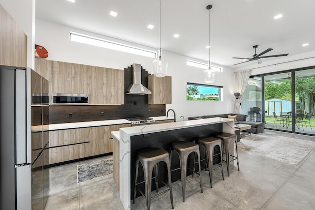 188 Yale Dr, Lake Worth Beach, FL 33460 - kitchen featuring light brown cabinets, wall chimney range hood, modern cabinets, and finished concrete floors