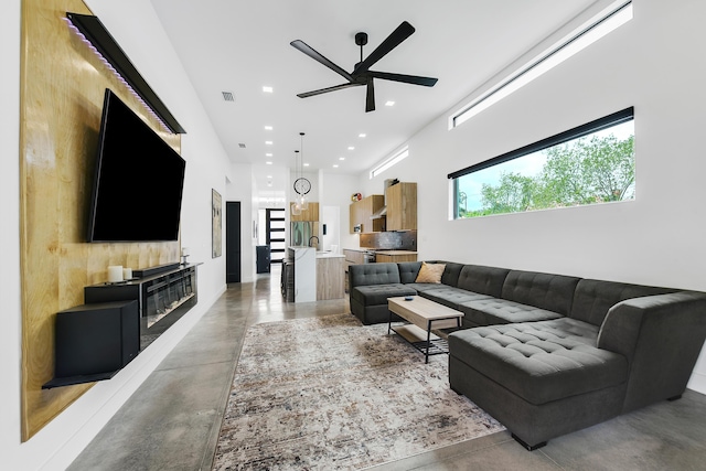 188 Yale Dr, Lake Worth Beach, FL 33460 - living area with a ceiling fan, recessed lighting, finished concrete flooring, visible vents, and a towering ceiling