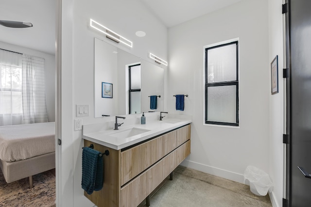 188 Yale Dr, Lake Worth Beach, FL 33460 - bathroom featuring a sink, double vanity, ensuite bath, and baseboards
