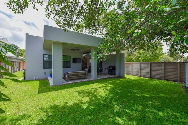 188 Yale Dr, Lake Worth Beach, FL 33460 - rear view of house with a ceiling fan, an outdoor hangout area, a patio area, stucco siding, and a fenced backyard