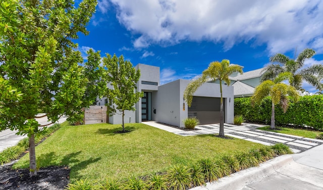 188 Yale Dr, Lake Worth Beach, FL 33460 - modern home featuring a front lawn, stucco siding, an attached garage, and concrete driveway