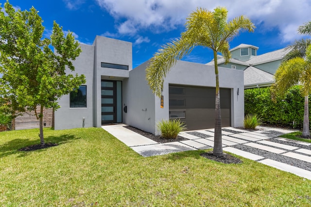 188 Yale Dr, Lake Worth Beach, FL 33460 - contemporary home featuring a front yard, stucco siding, driveway, and a garage